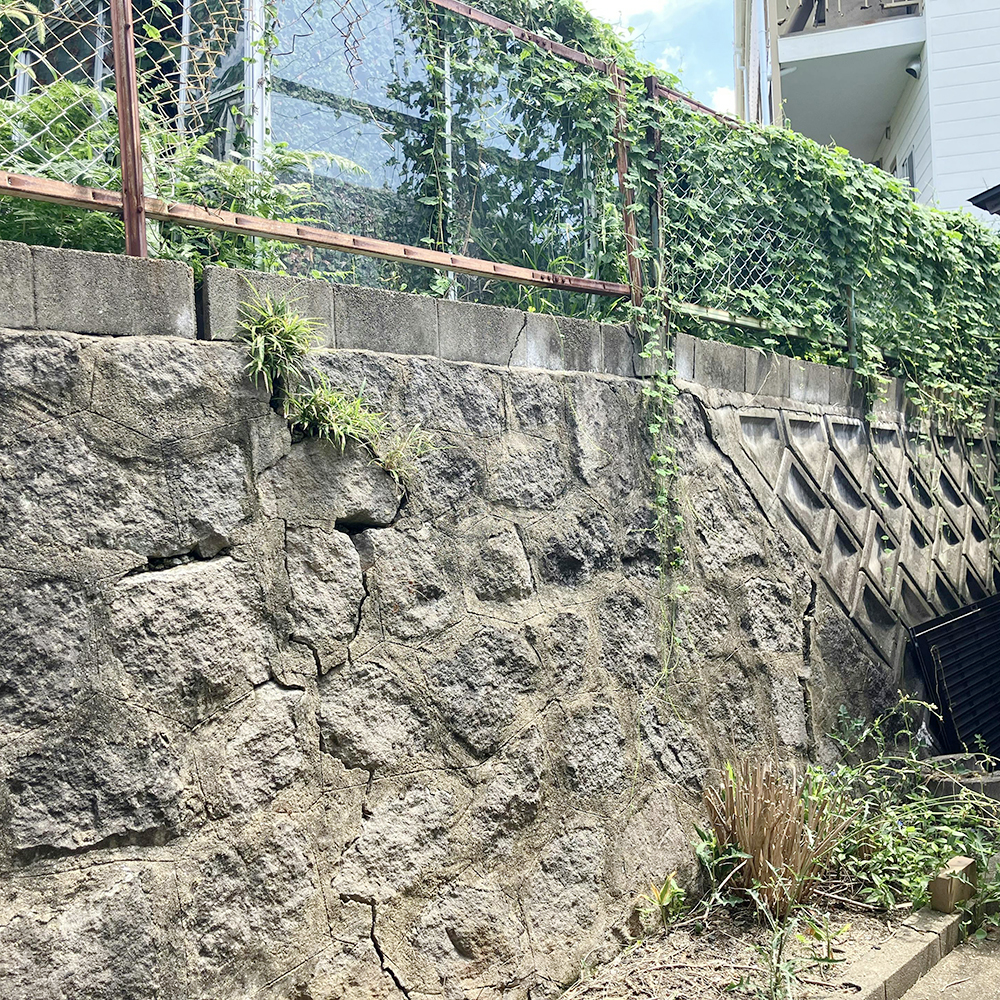 擁壁（ようへき）がひび割れて、隣のお宅の敷地に水漏れしている状況でした。